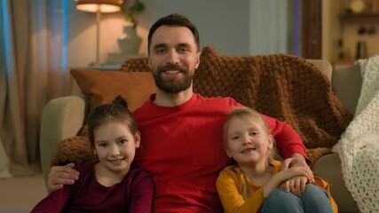 Family happy Caucasian man male dad single parent little daughters girls female siblings children cheerful smiling together affectionate father hug kids evening home weekend holiday adoption custody