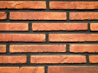 Background of retro orange narrow brickwork. Design and architecture concept