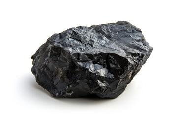 A single piece of coal sits on a clean and pure white surface, contrasting the two textures