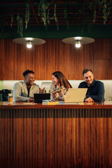 Happy diverse office staff at workspace discussing solar energy using.