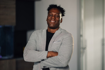 Close up of diverse confident businessman with arms crossed at office.