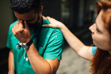 Medical professional being comforted by a colleague with empathy
