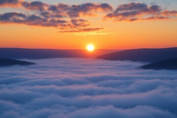 A serene sunrise over a fog-covered valley, with golden light breaking through and mountain ridges in the distance