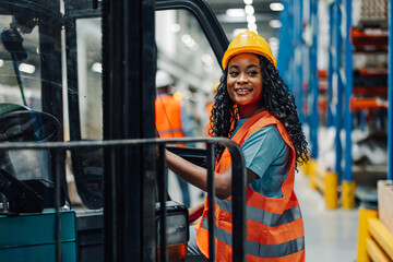 African american woman warehouse worker beside forklift in industrial space © Zamrznuti tonovi