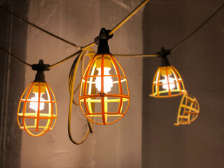 A decorative string of light bulbs beautifully hanging from a wire