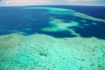 Aerial view of a vibrant coral reef and turquoise waters.