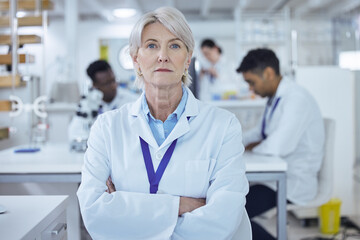Fototapeta premium Portrait, mature woman and arms crossed in lab, scientist and serious for science, confident and healthcare. Proud, medical research and process for medicine, person and cure for mpox in Denmark