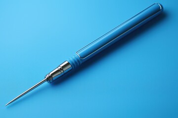 Close-up view of an electric cattle prod resting on a blue background for agricultural use