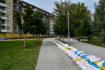 Bags of walking next to the house. Flood protection. Threat of flooding by the river. Wroclaw, Poland September 2024