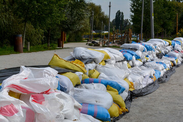 Bags of walking next to the house. Flood protection. Threat of flooding by the river. Wroclaw, Poland September 2024