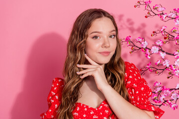 Photo portrait of attractive teen woman touch face cherry blooming dressed stylish red clothes isolated on pink color background