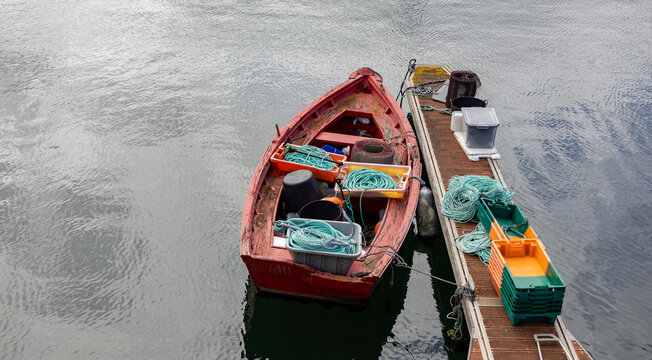 small red fishing boat and loaded cargo