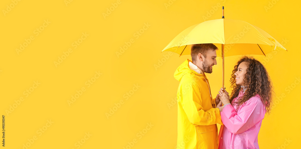 Poster happy young couple with umbrella on color background