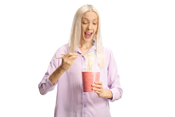 Excited young woman eating noodles from a takeaway box