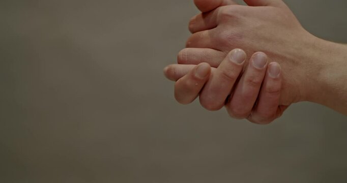 Close Up of Man Rubbing Hands Together