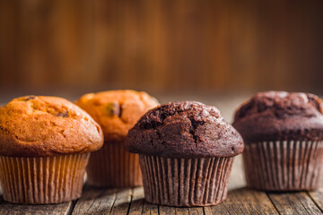Sweet chocolate muffin cakes. Cupcakes on wooden table.
