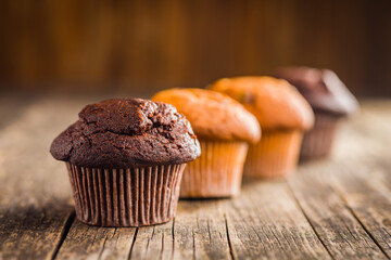 Sweet chocolate muffin cakes. Cupcakes on wooden table.