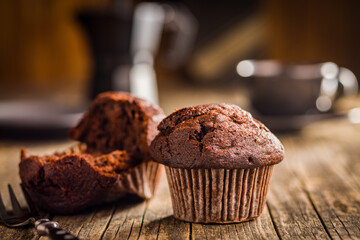 Sweet chocolate muffin cakes. Cupcakes on wooden table.
