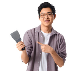 Young Asian man pointing at putty knife on white background