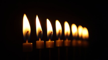 A Row of Burning Candles in the Darkness