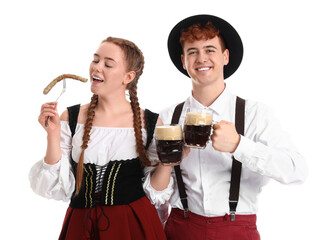Young couple in traditional German clothes with beer and sausage on white background