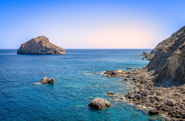 Scenic seascape in Amorgos Island, near the beach of Agia Anna, a small rocky beach famous for the scenes in the movie “The Big Blue”. In Cyclades, Greece.