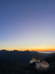 tent in a golden hour sunset looking over the pacific northwest mountains olympic mountain range © Caroline