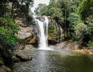 photo of a waterfall among the lush green forest