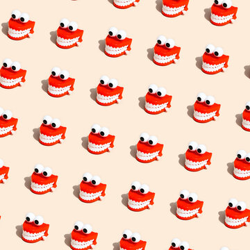 Repeating pattern of chattering teeth toys on beige