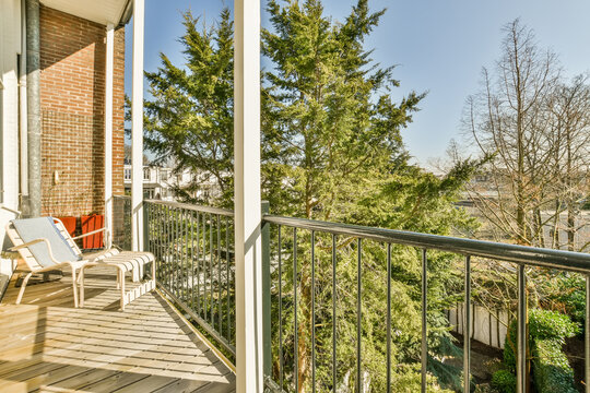 Balcony view with trees and residential backdrop