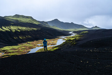 Lone traveler exploring the rain-soaked highlands of Iceland