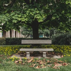 A photo of a concrete bench in a park. The bench is situated near a tree, with lush green leaves. There's a path leading to the bench. The background contains other benches and trees. 