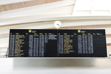 Airport departure boards displaying various flight times