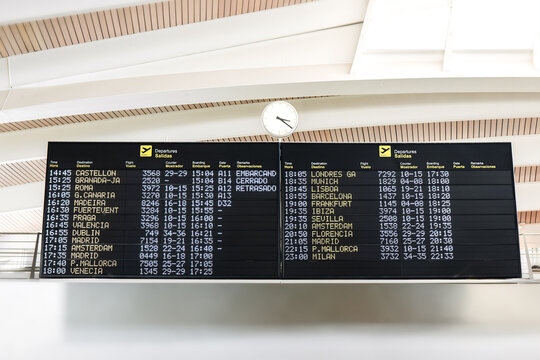 Airport departure boards displaying various flight times