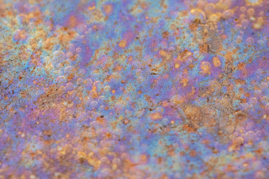 Intricate colors and textures in a small puddle