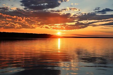 Fototapeta premium Stunning golden sunset over tranquil lake with dramatic cloudscape