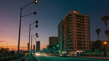 traffic in the city ،The city at night، tall buildings،fast cars ،dark highway