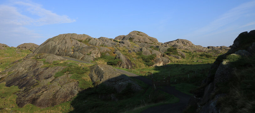 Gravel road and anorthosite rock formations, Rogaland, Norway.