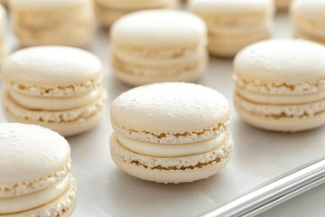 Fototapeta premium White Macarons with Cream Filling on Baking Sheet