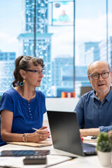 Senior people discussing a pension financial strategy with broker, receiving advice from agency expert to secure future income and family expenses. Guaranteeing life insurance plans.