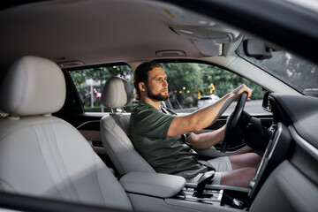 Man driving a car in a modern interior with soft lighting