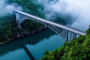 Fototapeta premium Grey steel bridge, stretching across a wide river, disappearing into the fog