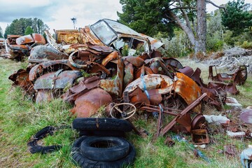 Abandoned and rusted classic cars  in the The historical Horopito Motor Wreckers - Smash Palace,...