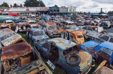 Abandoned and rusted classic cars  in the The historical Horopito Motor Wreckers - Smash Palace,...