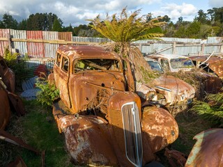 Abandoned and rusted classic cars  in the The historical Horopito Motor Wreckers - Smash Palace,...