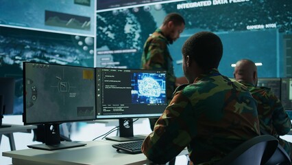 Programming engineer soldier handles AI brain and deep learning data on computer in command post, coordinates national defense operations. Neural network artificial intelligence science. Camera B.