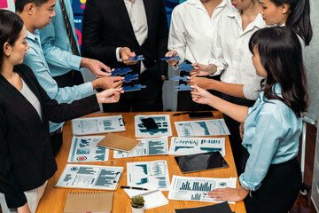 Multiethnic business people holding jigsaw pieces and merge them together as effective solution...