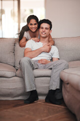 Obraz premium Portrait, home and hug with couple, love and relationship with romance, joyful and marriage. Face, apartment and woman with man on sofa, embrace and bonding together with happiness, smile or cheerful
