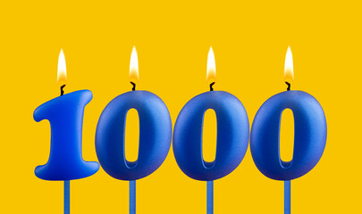 Blue candle number 1000 - Birthday on yellow background