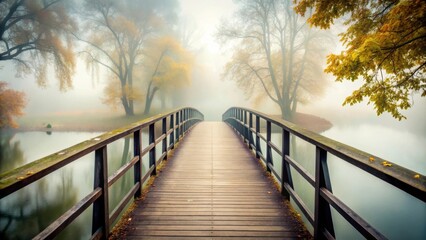 Fototapeta premium Mysterious and isolated footbridge covered in fog on a cold and lonely autumn day